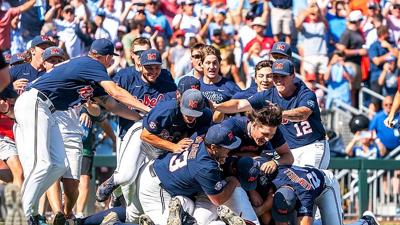 Jun 26, 2022; Omaha, NE, USA; Ole Miss Rebels players dogpile after defeating the Oklahoma Sooners at Charles Schwab Field. Mandatory Credit: Dylan Widger-USA TODAY Sports