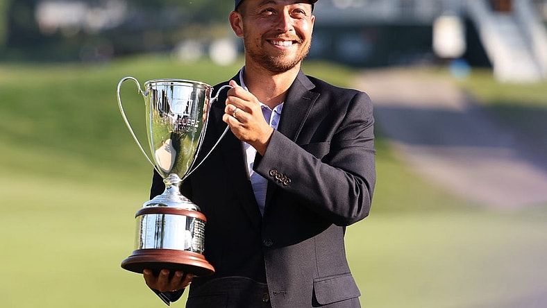 Jun 26, 2022; Cromwell, Connecticut, USA; Xander Schauffele holds up the Travelers Championship Trophy after winning the Travelers Championship golf tournament. Mandatory Credit: Vincent Carchietta-USA TODAY Sports