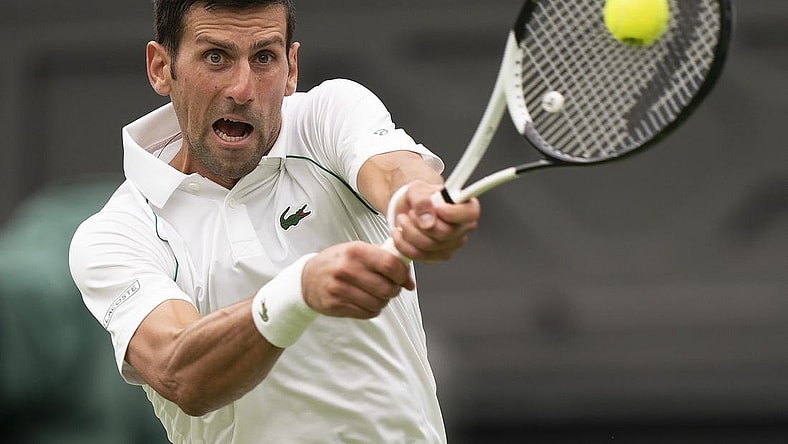 Jun 27, 2022; London, United Kingdom; Novak Djokovic (SRB) returns a shot during his first round match against Soonwoo Kwon (KOR) on day one at All England Lawn Tennis and Croquet Club. Mandatory Credit: Susan Mullane-USA TODAY Sports