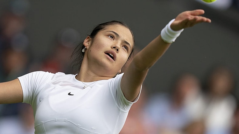 Jun 27, 2022; London, United Kingdom;  Emma Raducanu (GBR) tosses the ball to serve during her first round match against Alison Van Uytvanck (BEL) on day one at All England Lawn Tennis and Croquet Club. Mandatory Credit: Susan Mullane-USA TODAY Sports
