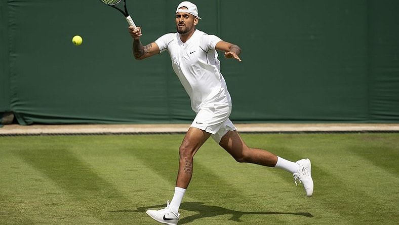 Jun 28, 2022; London, United Kingdom; Nick Kyrgios (AUS) returns a shot during her first round match against Paul Jubb (GBR) on day two at All England Lawn Tennis and Croquet Club. Mandatory Credit: Susan Mullane-USA TODAY Sports