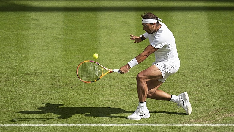 Jun 28, 2022; London, United Kingdom; Rafael Nadal (ESP) returns a shot during his first round match against Francisco Cerundolo (ARG) on day two at All England Lawn Tennis and Croquet Club. Mandatory Credit: Susan Mullane-USA TODAY Sports