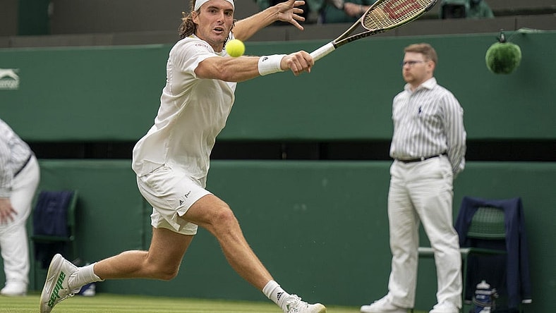 Jun 30, 2022; London, United Kingdom; Stefanos Tsitsipas (GRE) returns a shot during his match against Jordan Thompson (AUS) on day four at All England Lawn Tennis and Croquet Club. Mandatory Credit: Susan Mullane-USA TODAY Sports