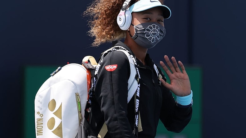 Mar 26, 2021; Miami, Florida, USA; Naomi Osaka of Japan waves while walking onto the court prior to her match against Ajla Tomljanovic of Australia (not pictured) in the second round in the Miami Open at Hard Rock Stadium. Mandatory Credit: Geoff Burke-USA TODAY Sports