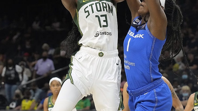 Aug 12, 2021; Phoenix, Arizona, USA; Seattle Storm center Ezi Magbegor (13) shoots the ball against Connecticut Sun forward Beatrice Mompremier (1) in the first half during the Inaugural WNBA Commissioners Cup Championship Game at Footprint Center. Mandatory Credit: Rick Scuteri-USA TODAY Sports