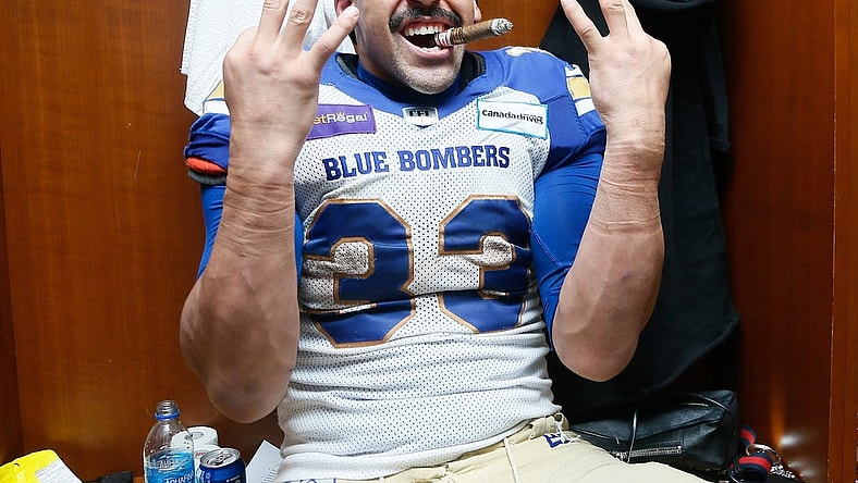 Dec 12, 2021; Hamilton, Ontario, CAN; Winnipeg Blue Bombers running back Andrew Harris (33) celebrates winning his third Grey Cup after a win over the Hamilton Tiger-Cats in the 108th Grey Cup football game at Tim Hortons Field. Mandatory Credit: John E. Sokolowski-USA TODAY Sports