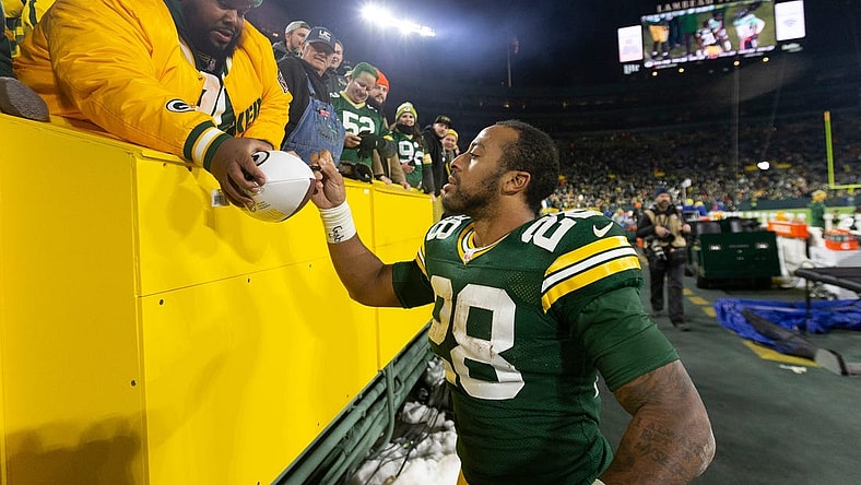 Green Bay Packers running back AJ Dillon (28) autographs a football after their game Sunday, December 12, 2021 at Lambeau Field in Green Bay, Wis. The Green Bay Packers beat the Chicago Bears 45-30.

Packers13 28