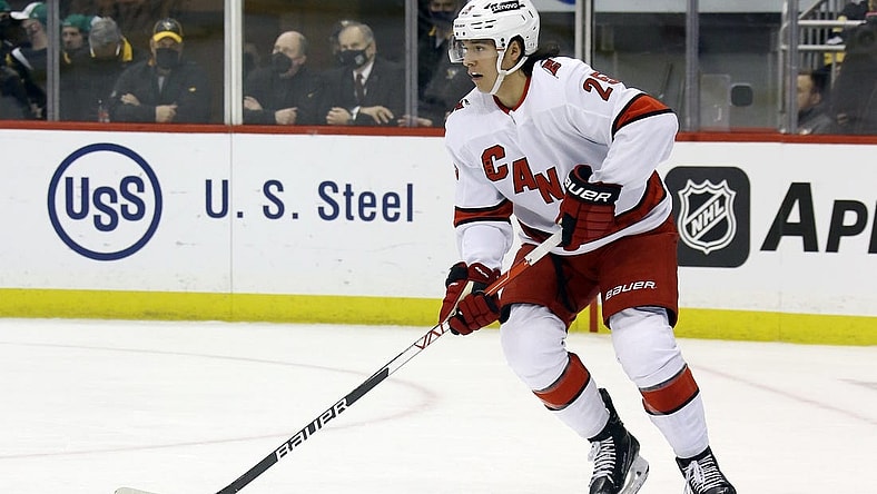 Mar 13, 2022; Pittsburgh, Pennsylvania, USA;  Carolina Hurricanes defenseman Ethan Bear (25) handles the puck against the Pittsburgh Penguins during the second period at PPG Paints Arena. Mandatory Credit: Charles LeClaire-USA TODAY Sports