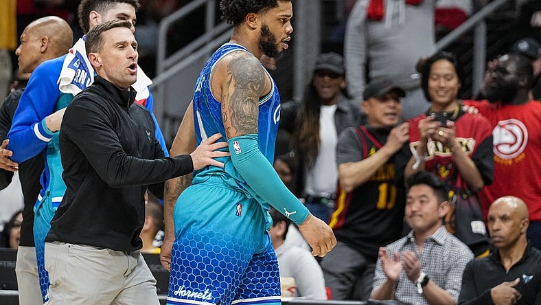 Apr 13, 2022; Atlanta, Georgia, USA; Charlotte Hornets forward Miles Bridges (0) is restrained after being called for a technical foul and being ejected from the game against the Atlanta Hawks during the second half at State Farm Arena. Mandatory Credit: Dale Zanine-USA TODAY Sports