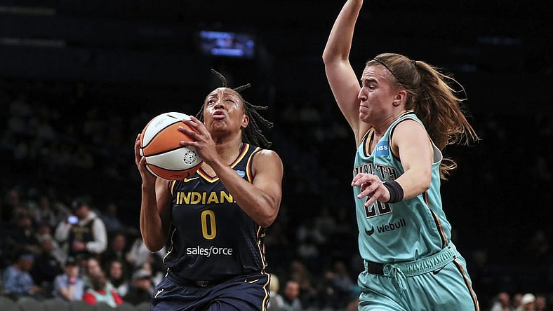 Jun 1, 2022; Brooklyn, New York, USA; Indiana Fever guard Kelsey Mitchell (0) drives past New York Liberty guard Sabrina Ionescu (20) in the first quarter at Barclays Center. Mandatory Credit: Wendell Cruz-USA TODAY Sports