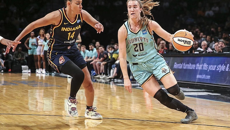 Jun 1, 2022; Brooklyn, New York, USA; New York Liberty guard Sabrina Ionescu (20) drives past Indiana Fever guard Bria Hartley (14) in the third quarter at Barclays Center. Mandatory Credit: Wendell Cruz-USA TODAY Sports