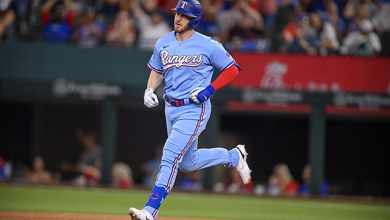 Jun 5, 2022; Arlington, Texas, USA; Texas Rangers designated hitter Mitch Garver (18) rounds the bases after he hits a two run home run against the Seattle Mariners during the eighth inning at Globe Life Field. Mandatory Credit: Jerome Miron-USA TODAY Sports