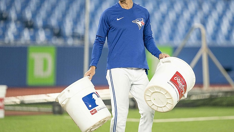 Jun 13, 2022; Toronto, Ontario, CAN; Toronto Blue Jays first base coach Mark Budzinski (53) carries two empty pails during batting practice against the Baltimore Orioles at Rogers Centre. Mandatory Credit: Nick Turchiaro-USA TODAY Sports