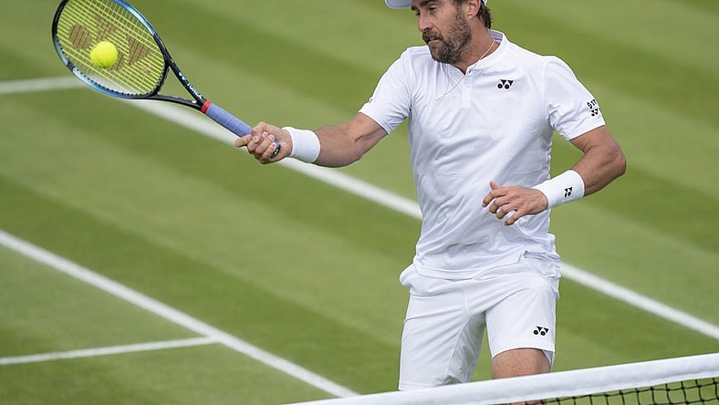 Jun 29, 2022; London, United Kingdom; Steve Johnson (USA) returns a shot during his second round match against Ryan Peniston (GBR) on day three at All England Lawn Tennis and Croquet Club. Mandatory Credit: Susan Mullane-USA TODAY Sports
