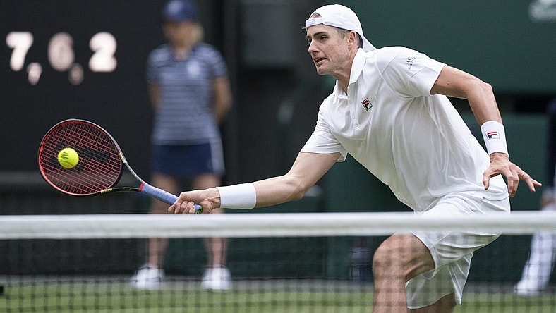 Jun 29, 2022; London, United Kingdom; John Isner (USA) returns a shot during his second round match against Andy Murray (GBR) on day three at All England Lawn Tennis and Croquet Club. Mandatory Credit: Susan Mullane-USA TODAY Sports