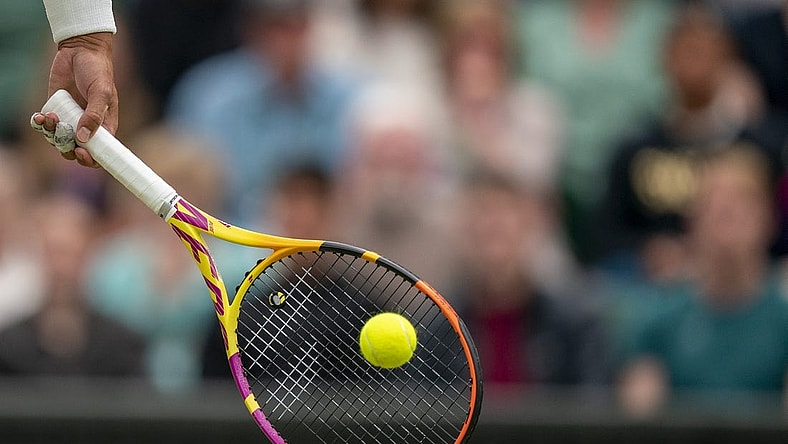 Jun 30, 2022; London, United Kingdom; A detail view of a ball on the racket of Rafael Nadal (ESP) during his match against Ricardas Berankis (LTU) on day four at All England Lawn Tennis and Croquet Club. Mandatory Credit: Susan Mullane-USA TODAY Sports