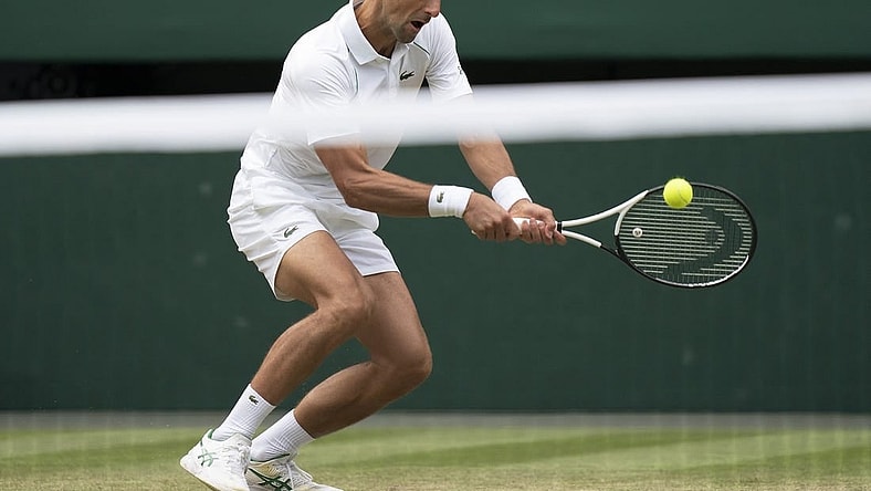 Jul 1, 2022; London, United Kingdom; Novak Djokovic (SRB) returns a shot during his match against Miomir Kecmanovic (SRB) on day five at All England Lawn Tennis and Croquet Club. Mandatory Credit: Susan Mullane-USA TODAY Sports