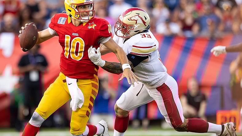 Jul 3, 2022; Canton, OH, USA; Philadelphia Stars quarterback Case Cookus (10) looks for a receiver under pressure from Birmingham Stallions inside linebacker Scooby Wright (33) during the first quarter at Tom Benson Hall of Fame Stadium. Mandatory Credit: Scott Galvin-USA TODAY Sports