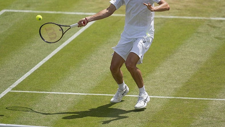 Jul 4, 2022; London, United Kingdom; Alex De Minaur (AUS) returns a shot during his match against Cristian Garin (CHI) on day eight at All England Lawn Tennis and Croquet Club. Mandatory Credit: Susan Mullane-USA TODAY Sports