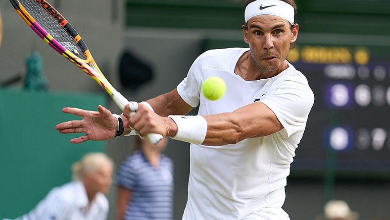 Jul 6, 2022; London, England, United Kingdom; Rafael Nadal (ESP) returns a shot during his quarter finals men   s singles match against Taylor Fritz (USA) on Centre court at All England Lawn Tennis and Croquet Club. Mandatory Credit: Peter van den Berg-USA TODAY Sports