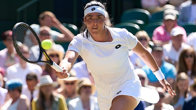 Jul 7, 2022; London, England, United Kingdom;  Ons Jabeur (TUN) returns a shot during  her semi finals women   s singles match against Tatjana Maria (GER) on Centre court at All England Lawn Tennis and Croquet Club. Mandatory Credit: Peter van den Berg-USA TODAY Sports