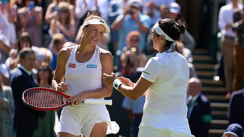Jul 7, 2022; London, England, United Kingdom;  Ons Jabeur (TUN), pictured right, celebrates at the net after her semi finals women s singles match against Tatjana Maria (GER) who is a close friend on Centre court at All England Lawn Tennis and Croquet Club. Mandatory Credit: Peter van den Berg-USA TODAY Sports