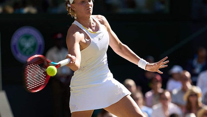Jul 7, 2022; London, England, United Kingdom;  Elena Rybakina (KAZ) returns a shot during her semi-finals women   s singles match against Simona Halep (ROU) on Centre court at All England Lawn Tennis and Croquet Club. Mandatory Credit: Peter van den Berg-USA TODAY Sports
