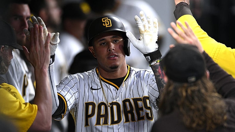 Jul 7, 2022; San Diego, California, USA; San Diego Padres third baseman Manny Machado (13) is congratulated in the dugout after hitting a home run against the San Francisco Giants during the fifth inning at Petco Park. Mandatory Credit: Orlando Ramirez-USA TODAY Sports