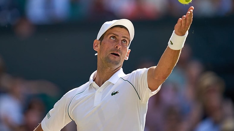 Jul 8, 2022; London, England, United Kingdom;  Novak Djokovic (SRB) serves during his semi finals men s singles match against Cameron Norrie (GBR) on Centre court at All England Lawn Tennis and Croquet Club. Mandatory Credit: Peter van den Berg-USA TODAY Sports