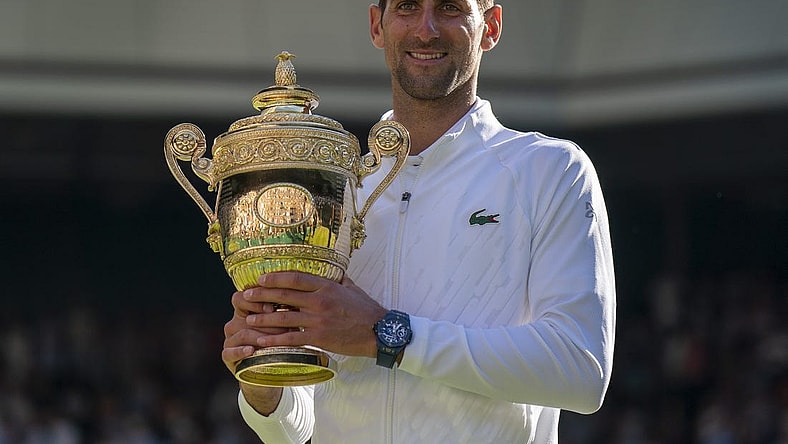 Jul 10, 2022; London, United Kingdom; Novak Djokovic (SRB) poses with the trophy after winning the men   s final against Nick Kyrgios (not pictured) on day 14 at All England Lawn Tennis and Croquet Club. Mandatory Credit: Susan Mullane-USA TODAY Sports