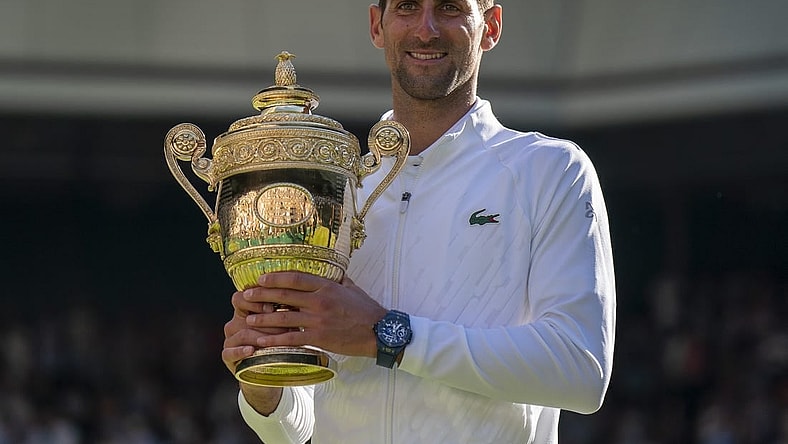 Jul 10, 2022; London, United Kingdom; Novak Djokovic (SRB) poses with the trophy after winning the men's final against Nick Kyrgios (not pictured) on day 14 at All England Lawn Tennis and Croquet Club. Mandatory Credit: Susan Mullane-USA TODAY Sports