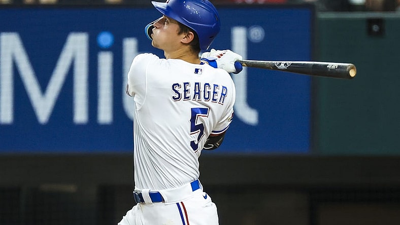 Jul 12, 2022; Arlington, Texas, USA; Texas Rangers shortstop Corey Seager (5) hits a home run during the ninth inning against the Oakland Athletics at Globe Life Field. Mandatory Credit: Kevin Jairaj-USA TODAY Sports