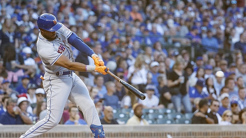 Jul 14, 2022; Chicago, Illinois, USA; New York Mets right fielder Starling Marte (6) hits an RBI-single against the Chicago Cubs during the second inning at Wrigley Field. Mandatory Credit: Kamil Krzaczynski-USA TODAY Sports