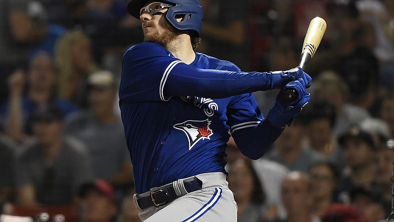 Jul 22, 2022; Boston, Massachusetts, USA;  Toronto Blue Jays catcher Danny Jansen (9) hits a home run during the fourth inning against the Boston Red Sox at Fenway Park. Mandatory Credit: Bob DeChiara-USA TODAY Sports