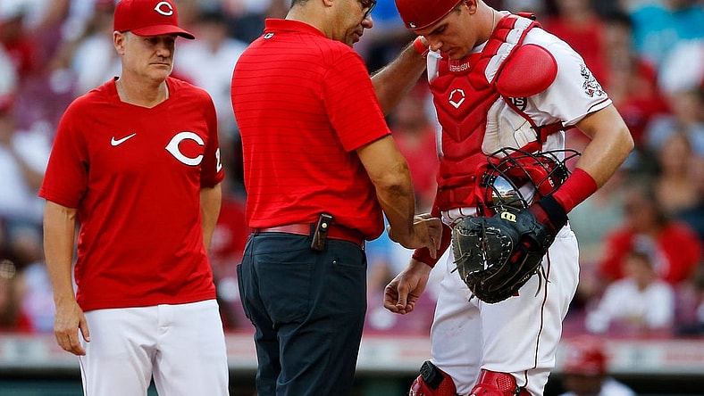 Cincinnati Reds catcher Tyler Stephenson (37) is examined by team trainer Tomas Vera after being hit in the arm by a foul ball in the first inning of the MLB National League game between the Cincinnati Reds and the St. Louis Cardinals at Great American Ball Park in downtown Cincinnati on Friday, July 22, 2022.

St Louis Cardinals At Cincinnati Reds