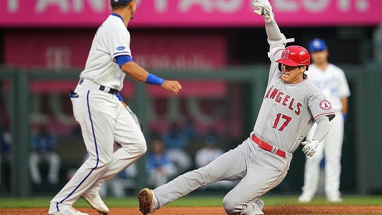 Jul 25, 2022; Kansas City, Missouri, USA; Los Angeles Angels designated hitter Shohei Ohtani (17) slides into second base for a double as Kansas City Royals shortstop Nicky Lopez (left) awaits the throw during the third inning at Kauffman Stadium. Mandatory Credit: Jay Biggerstaff-USA TODAY Sports