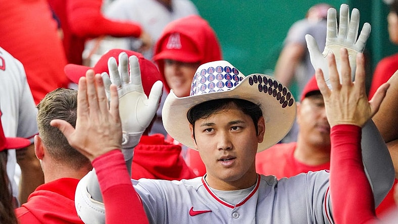 Jul 26, 2022; Kansas City, Missouri, USA; Los Angeles Angels designated hitter Shohei Ohtani (17) is congratulated in the dugout against the Kansas City Royals after hitting a solo home run in the third inning of the game at Kauffman Stadium. Mandatory Credit: Denny Medley-USA TODAY Sports
