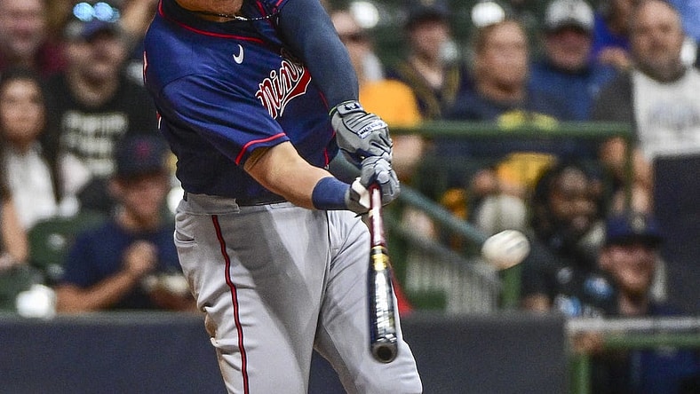 Jul 26, 2022; Milwaukee, Wisconsin, USA; Minnesota Twins third baseman Gio Urshela (15) hits a three run home run in the fifth inning against the Milwaukee Brewers at American Family Field. Mandatory Credit: Benny Sieu-USA TODAY Sports