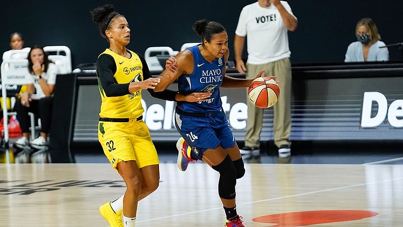 Sep 22, 2020; Bradenton, Florida, USA; Minnesota Lynx forward Napheesa Collier (24) dribbles the ball as Seattle Storm forward Alysha Clark (32) defends during the first half at IMG Academy. Mandatory Credit: Douglas DeFelice-USA TODAY Sports