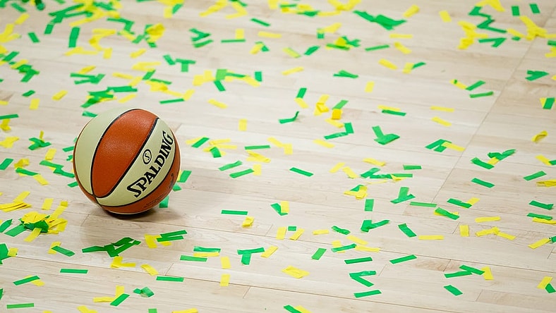 Oct 6, 2020; Bradenton, Florida, USA; A game ball rests on the court amidst green and yellow confetti after the Seattle Storm win the 2020 WNBA Finals at IMG Academy. Mandatory Credit: Mary Holt-USA TODAY Sports