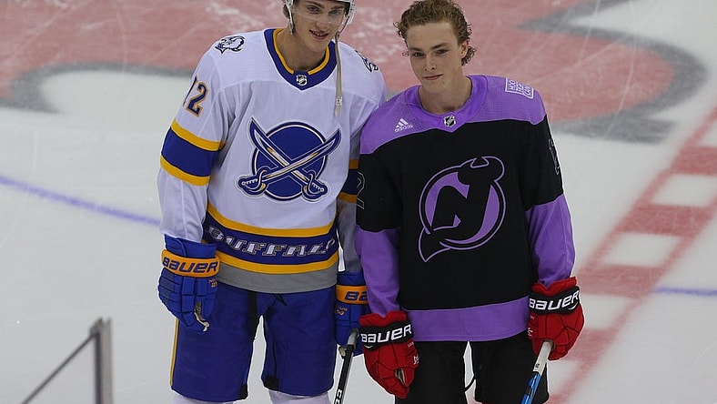 Apr 6, 2021; Newark, New Jersey, USA; Buffalo Sabres right wing Tage Thompson (72) and New Jersey Devils right wing Tyce Thompson (12) pose together during the pregame warmups at Prudential Center. It is the first career NHL game for Tyce Thompson. Mandatory Credit: Ed Mulholland-USA TODAY Sports