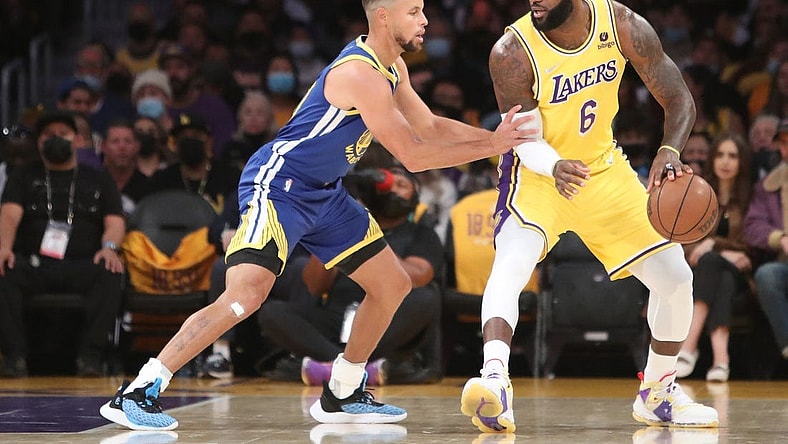 Oct 19, 2021; Los Angeles, California, USA; Los Angeles Lakers forward LeBron James (6) dribbles a ball against Golden State Warriors guard Stephen Curry (30) during the first quarter at Staples Center. Mandatory Credit: Kiyoshi Mio-USA TODAY Sports