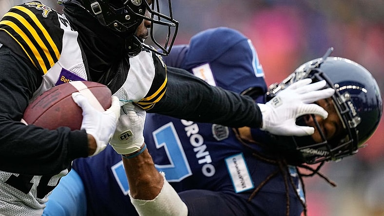 Dec 5, 2021; Toronto, Ontario, CAN; Hamilton Tiger-Cats wide receiver Brandon Banks (16) and Toronto Argonauts defensive back Jalen Collins (7) after a pass reception during the Canadian Football League Eastern Conference Final game at BMO Field. Mandatory Credit: John E. Sokolowski-USA TODAY Sports