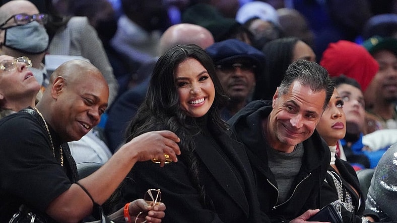 Feb 20, 2022; Cleveland, Ohio, USA; Vanessa Bryant sits between Dave Chapelle (left) and Lakers general manager Rob Pelinka (right) during the 2022 NBA All-Star Game at Rocket Mortgage FieldHouse. Mandatory Credit: Kyle Terada-USA TODAY Sports