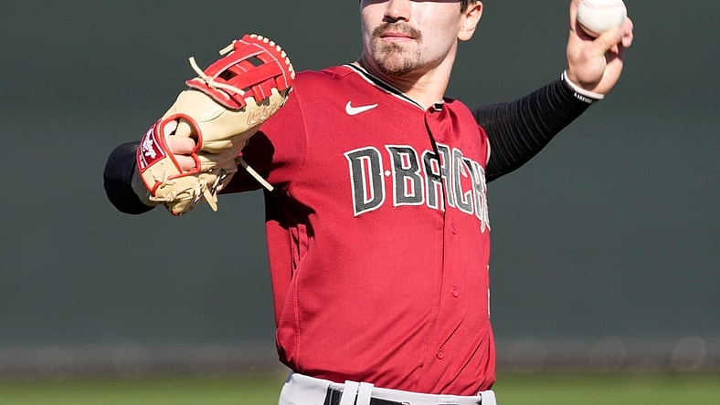 Feb 21, 2022; Scottsdale, Ariz., U.S.;  Diamondbacks minor league outfielder Corbin Carroll throws during a select training camp for minor-league players not covered by the Players Association at Salt River Fields. MLB continues to be in a lockout after the expiration of the collective bargaining agreement Dec. 2. Mandatory Credit: Michael Chow-Arizona Republic

Baseball Diamondbacks Select Minor League Camp