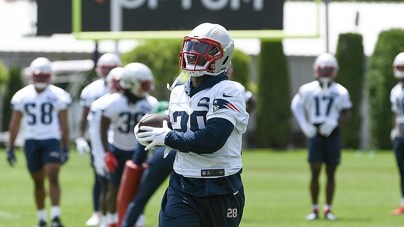 May 23, 2022; Foxborough, MA, USA; New England Patriots running back James White (28) catches the ball at the team's OTA at Gillette Stadium. Mandatory Credit: Eric Canha-USA TODAY Sports