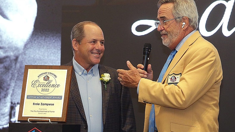 Ken Zampese ,left, accepts the Pro Football Hall of Fame Assistant Coaches Award of Excellence for his father Ernie Zampese from master of ceremonies Hall of Famer Dan Fouts at the Pro Football Hall of Fame Thursday, June 30, 2022.

Ssh36241