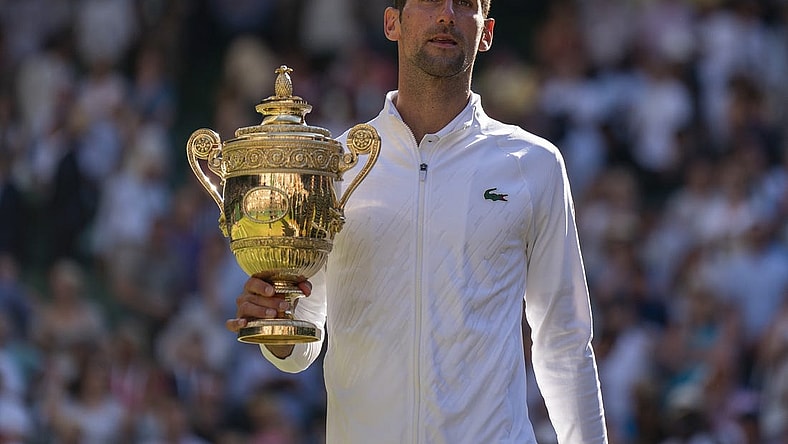 Jul 10, 2022; London, United Kingdom; Novak Djokovic (SRB) poses with the trophy after winning the men s final against Nick Kyrgios (not pictured) on day 14 at All England Lawn Tennis and Croquet Club. Mandatory Credit: Susan Mullane-USA TODAY Sports