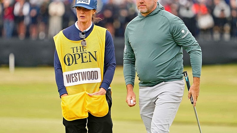 Jul 14, 2022; St. Andrews, SCT; Lee Westwood stands on the 17th green with his wife and caddie Helen Storey during the first round of the 150th Open Championship golf tournament at St. Andrews Old Course. Mandatory Credit: Rob Schumacher-USA TODAY Sports