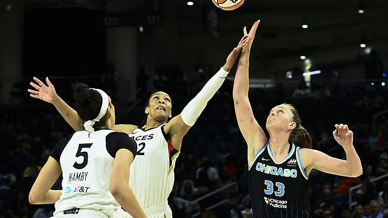 Jul 26, 2022; Chicago, IL, USA;  Chicago Sky forward Emma Meesseman (33) fights for the ball against Las Vegas Aces forward A'ja Wilson (22) and Las Vegas Aces forward Dearica Hamby (5) during the first half of the Commissioners Cup-Championships at Wintrust Arena. Mandatory Credit: Matt Marton-USA TODAY Sports